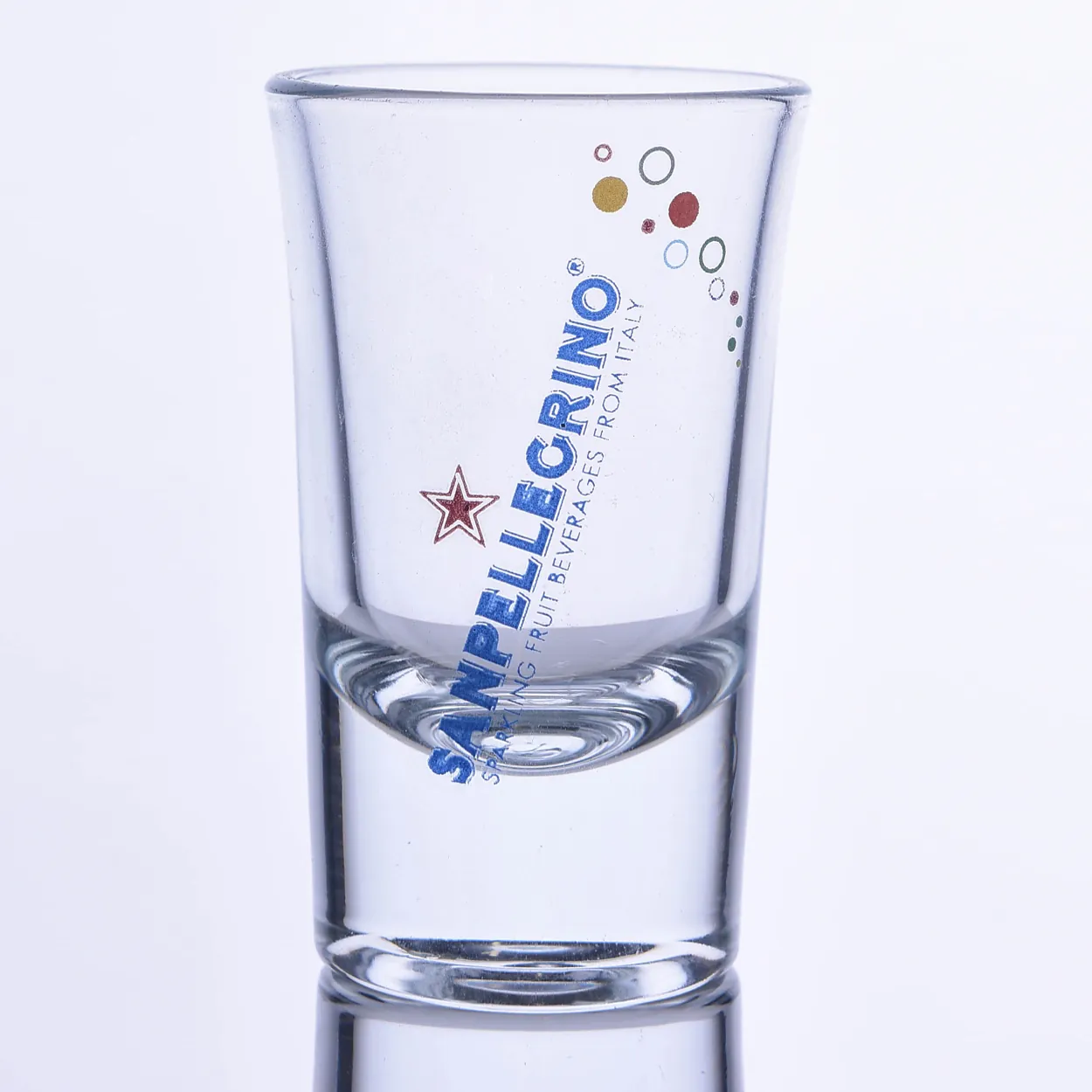 Blue diagonal text and red star logo-printed shot glass — Model 1003c